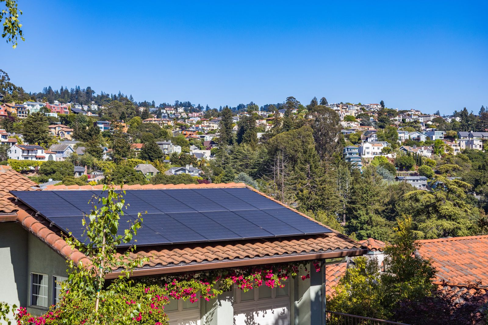 A Fresno home with a rooftop solar array under a clear Valley sky